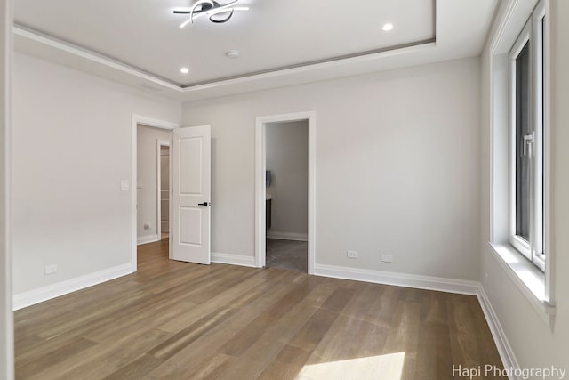 1906 Lee St, Des Plaines, IL 60018 - unfurnished bedroom featuring recessed lighting, wood finished floors, and a raised ceiling