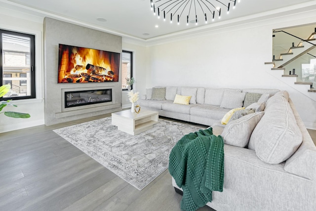1906 Lee St, Des Plaines, IL 60018 - living area featuring wood finished floors, stairs, a glass covered fireplace, baseboards, and crown molding