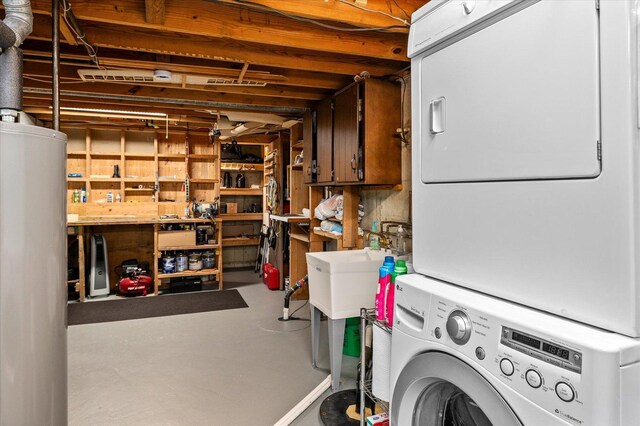 unfinished below grade area with stacked washing maching and dryer, a sink, and water heater