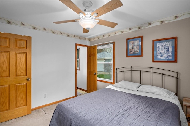 bedroom with light colored carpet, baseboards, and ceiling fan
