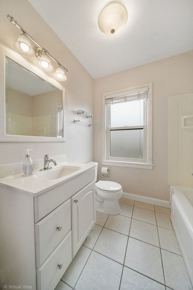 bathroom with tile patterned flooring, vanity, a tub, and toilet