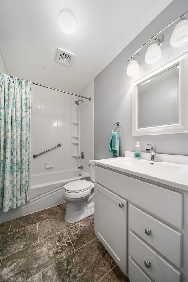 full bath featuring stone tile floors, vanity, visible vents, toilet, and shower / bath combo