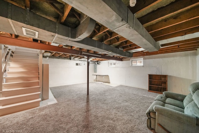 basement with visible vents, stairway, carpet flooring, and electric panel