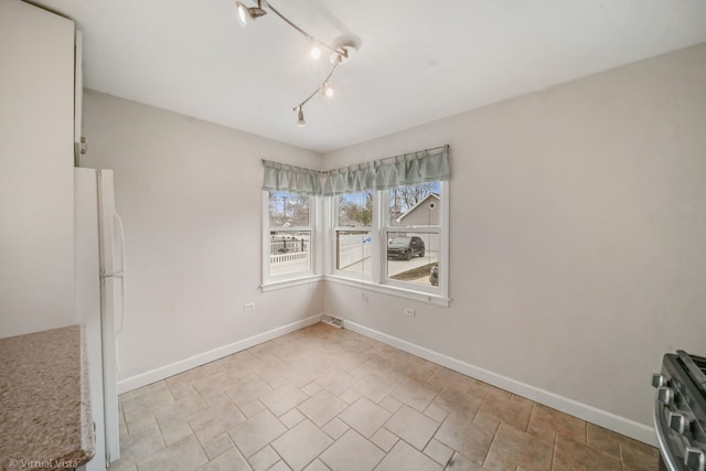 unfurnished dining area featuring visible vents and baseboards