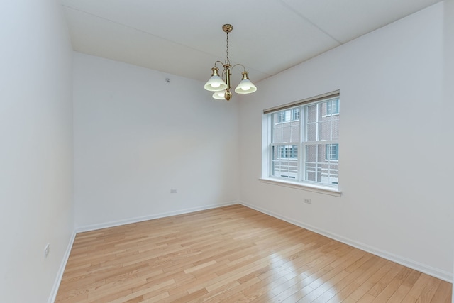 210 N Addison Ave Unit 206, Elmhurst, IL 60126 - spare room with light wood-style floors, baseboards, and an inviting chandelier
