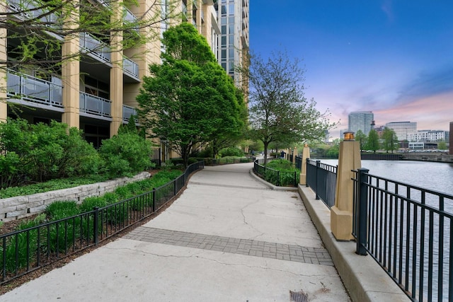 surrounding community with a water view and a city view