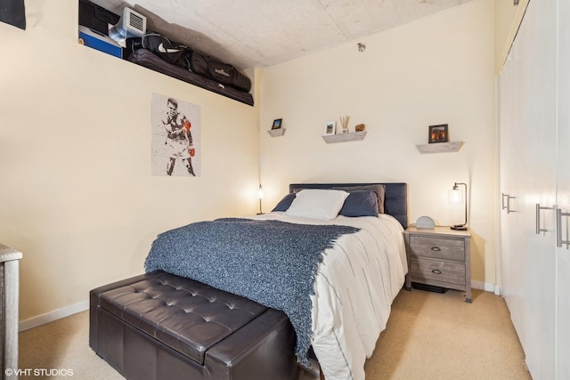 bedroom with light colored carpet and baseboards