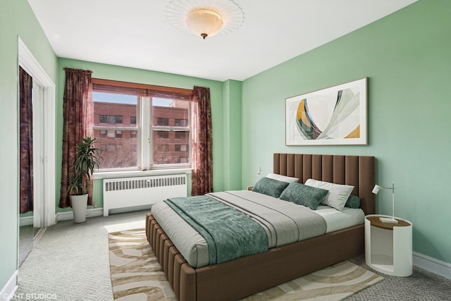 carpeted bedroom featuring radiator heating unit and baseboards