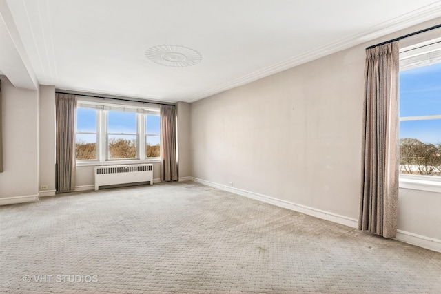 carpeted empty room featuring baseboards, radiator, and plenty of natural light