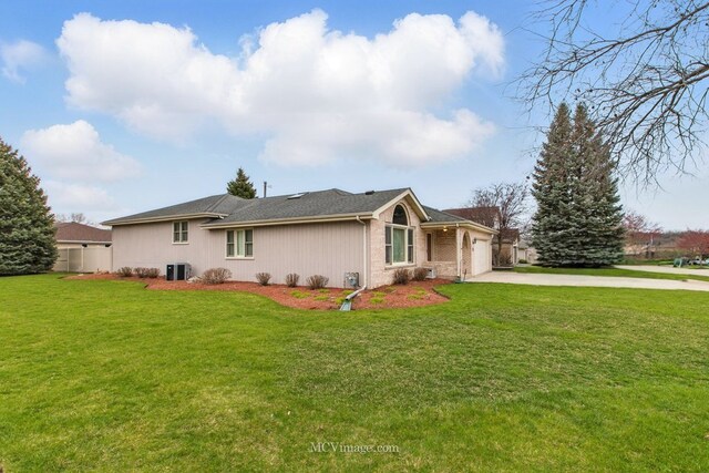 633 Mendota Ln, Romeoville, IL 60446 - rear view of house with a yard, an attached garage, cooling unit, and driveway
