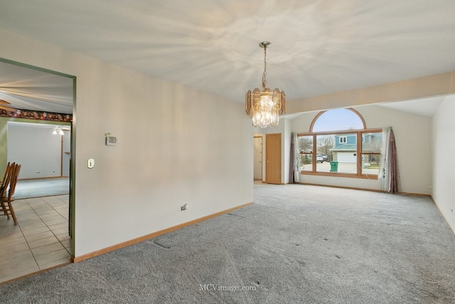 633 Mendota Ln, Romeoville, IL 60446 - carpeted empty room featuring a chandelier, baseboards, tile patterned flooring, and lofted ceiling