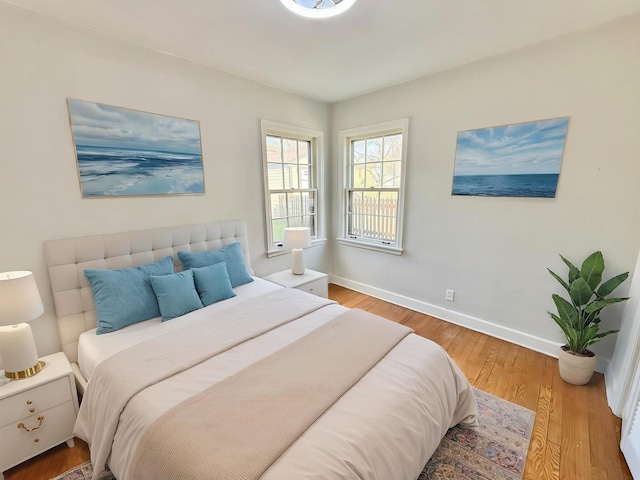bedroom with baseboards and wood finished floors