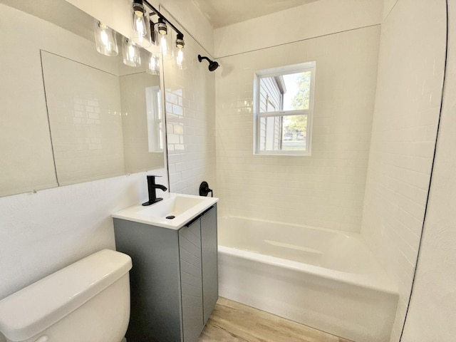 full bathroom featuring toilet, vanity,  shower combination, and wood finished floors