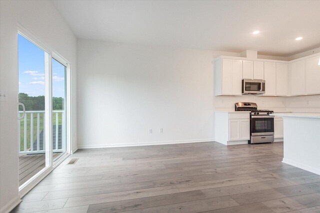 kitchen featuring light countertops, visible vents, light wood-style floors, and appliances with stainless steel finishes