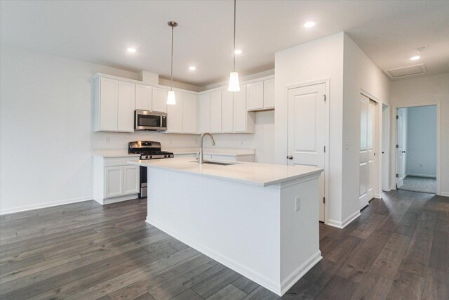 kitchen featuring white cabinetry, dark wood-style floors, a sink, and appliances with stainless steel finishes