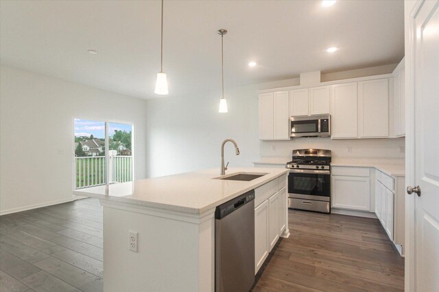 kitchen featuring light countertops, a sink, white cabinetry, dark wood-style floors, and stainless steel appliances