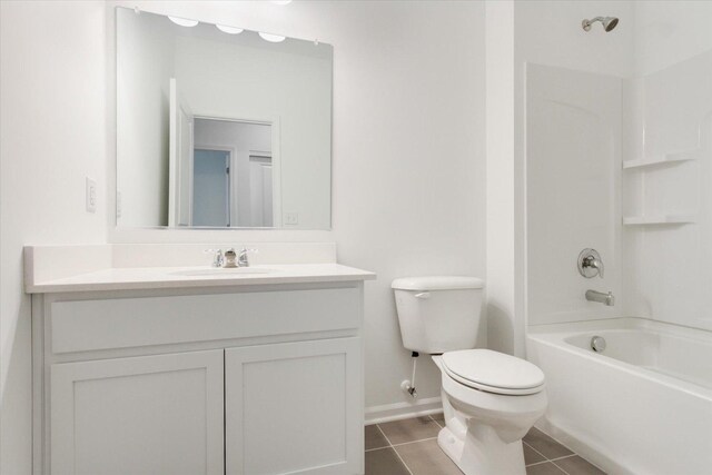 bathroom with baseboards, toilet, tile patterned floors, vanity, and shower / bathtub combination