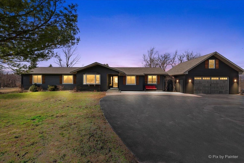 41W168 Powers Rd, Huntley, IL 60142 - view of front facade with a front yard, a garage, and aphalt driveway