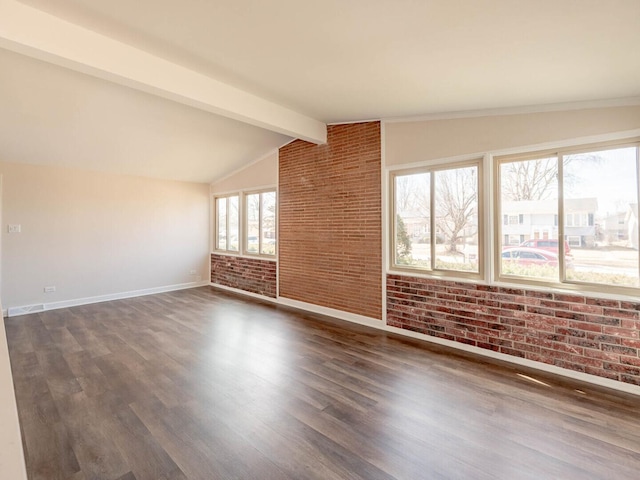 347 Madison Ave, Calumet City, IL 60409 - empty room featuring baseboards, lofted ceiling with beams, brick wall, and dark wood-style flooring