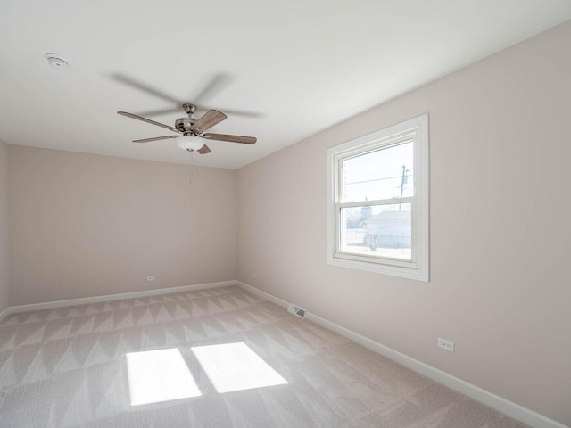 347 Madison Ave, Calumet City, IL 60409 - empty room featuring light colored carpet, visible vents, baseboards, and a ceiling fan