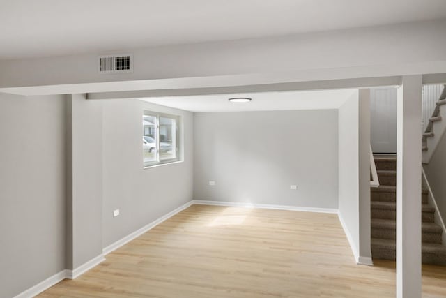 753 Rogers Rd, Romeoville, IL 60446 - below grade area featuring light wood-style flooring, baseboards, stairway, and visible vents