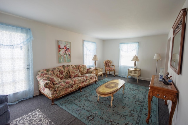 carpeted living room with baseboards
