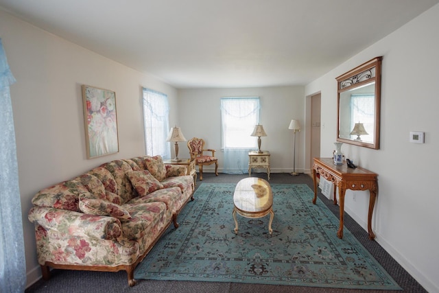 living room with baseboards and carpet