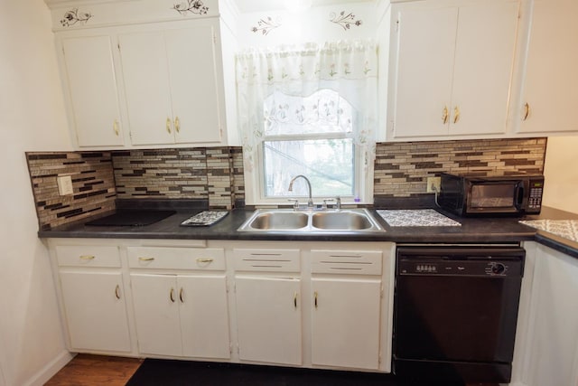 kitchen featuring a sink, white cabinetry, black dishwasher, dark countertops, and decorative backsplash