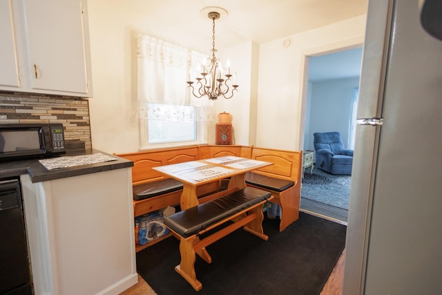 dining space with an inviting chandelier