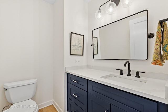 21 E Huron St Unit 1806, Chicago, IL 60611 - bathroom featuring vanity, toilet, wood finished floors, and baseboards