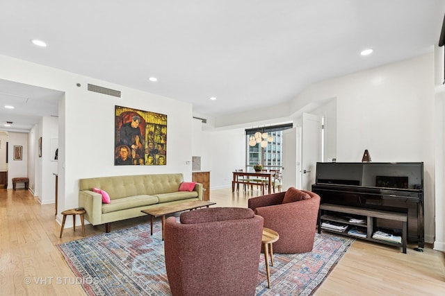 21 E Huron St Unit 1806, Chicago, IL 60611 - living room featuring a chandelier, light wood-style floors, recessed lighting, and baseboards