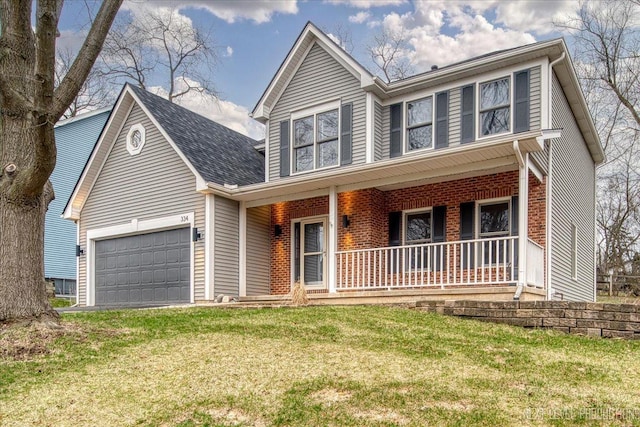 traditional home with a front yard, an attached garage, a porch, and brick siding