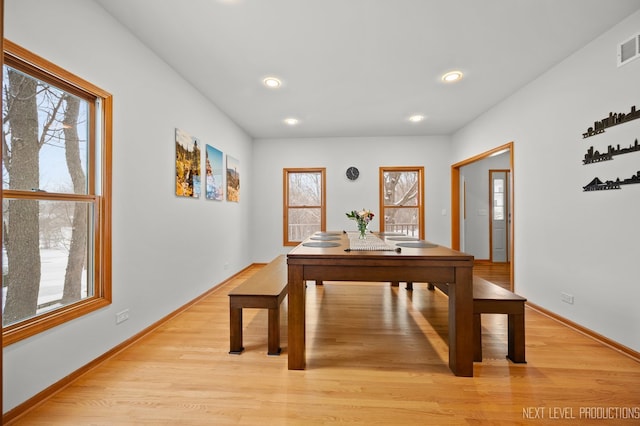 dining space with baseboards, light wood-type flooring, and recessed lighting