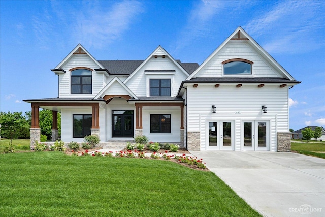 483 Deerfield Dr, Oswego, IL 60543 - view of front of house featuring a shingled roof, a front yard, stone siding, and french doors