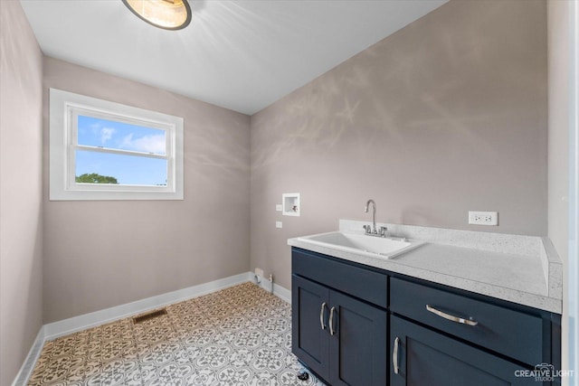 483 Deerfield Dr, Oswego, IL 60543 - clothes washing area featuring washer hookup, baseboards, a sink, and cabinet space