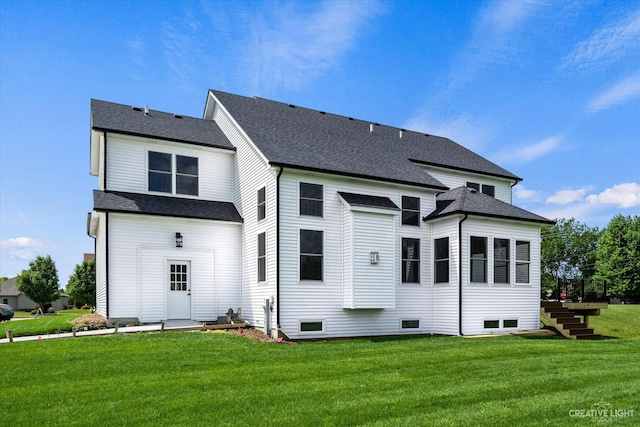 483 Deerfield Dr, Oswego, IL 60543 - back of house with stairs, roof with shingles, and a yard
