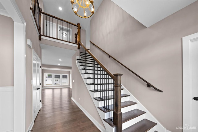 483 Deerfield Dr, Oswego, IL 60543 - stairway with recessed lighting, baseboards, a chandelier, a towering ceiling, and wood finished floors