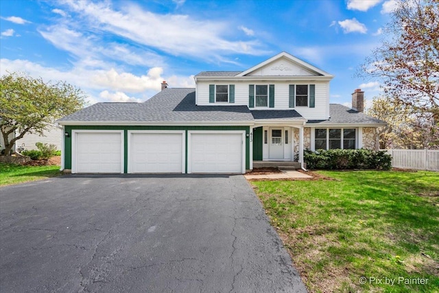 413 Edinburgh Ln, West Dundee, IL 60118 - traditional home with fence, aphalt driveway, a garage, a front yard, and a chimney