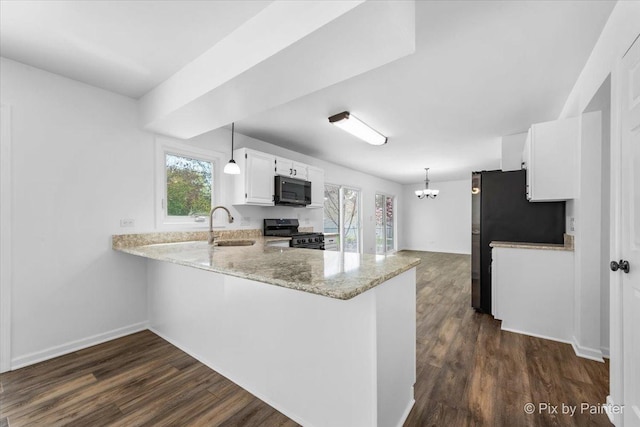 413 Edinburgh Ln, West Dundee, IL 60118 - kitchen featuring range with gas cooktop, black microwave, a sink, a peninsula, and dark wood-type flooring
