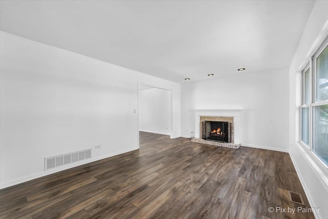 413 Edinburgh Ln, West Dundee, IL 60118 - unfurnished living room featuring visible vents, dark wood finished floors, a brick fireplace, and baseboards