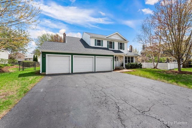 413 Edinburgh Ln, West Dundee, IL 60118 - traditional home featuring driveway, a chimney, fence, a front lawn, and an attached garage