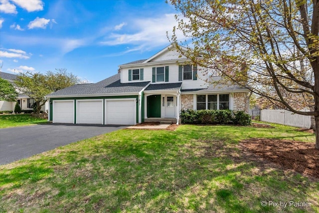 413 Edinburgh Ln, West Dundee, IL 60118 - traditional-style house featuring a garage, fence, driveway, and a front yard