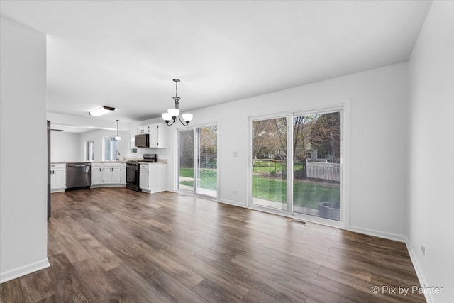413 Edinburgh Ln, West Dundee, IL 60118 - unfurnished living room with visible vents, a sink, baseboards, a chandelier, and dark wood-type flooring