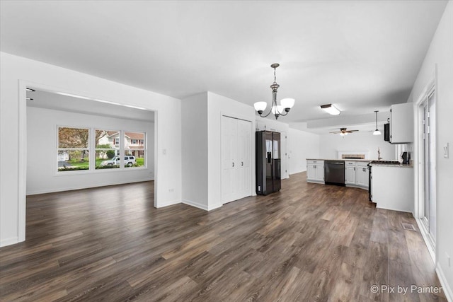 413 Edinburgh Ln, West Dundee, IL 60118 - unfurnished living room featuring baseboards, visible vents, dark wood-style floors, and ceiling fan with notable chandelier