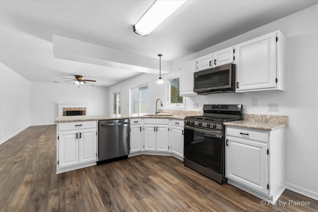 413 Edinburgh Ln, West Dundee, IL 60118 - kitchen featuring white cabinets, appliances with stainless steel finishes, a sink, a peninsula, and a ceiling fan