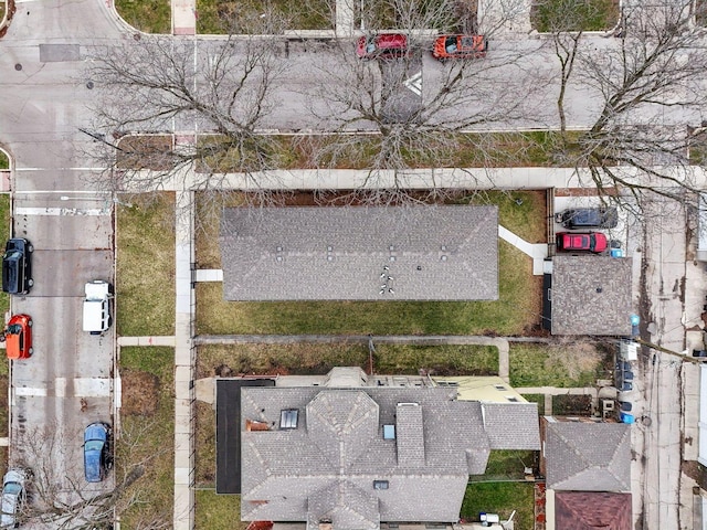 view of street featuring street lights, sidewalks, curbs, and a residential view