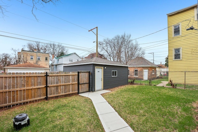 view of yard with a fenced backyard and an outdoor structure