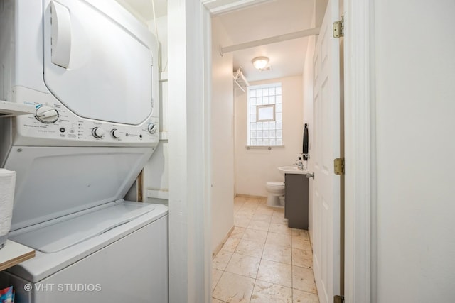 7001 W Altgeld St Unit G, Chicago, IL 60707 - laundry area with stacked washer / dryer and light marble finish flooring