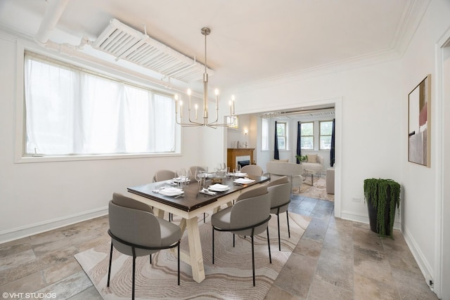 7001 W Altgeld St Unit G, Chicago, IL 60707 - dining area with stone tile flooring, a chandelier, baseboards, and crown molding