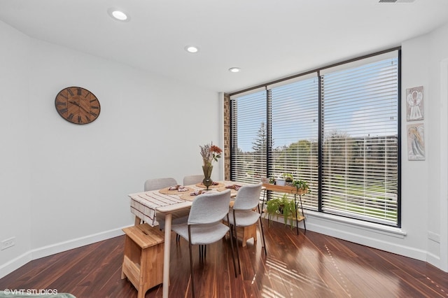 dining room featuring baseboards, recessed lighting, dark wood-style flooring, and a healthy amount of sunlight